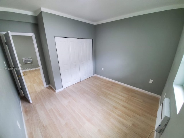 unfurnished bedroom with light wood finished floors, baseboards, and ornamental molding