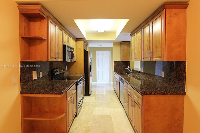 kitchen featuring open shelves, appliances with stainless steel finishes, a tray ceiling, and backsplash