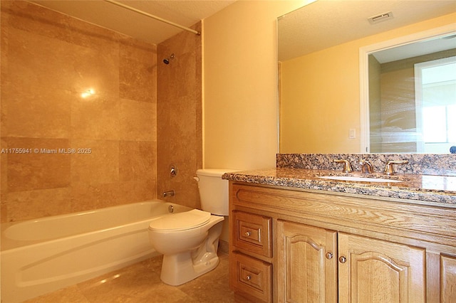 full bathroom with shower / tub combination, toilet, vanity, visible vents, and tile patterned floors