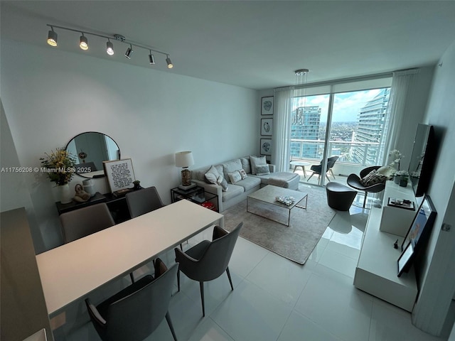 living room with light tile patterned floors, rail lighting, and floor to ceiling windows