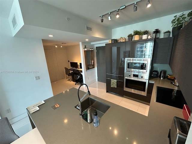 kitchen with light tile patterned floors, visible vents, stainless steel appliances, and a sink