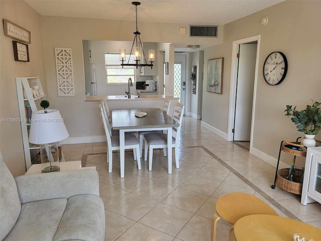 dining space featuring visible vents, a notable chandelier, baseboards, and light tile patterned floors