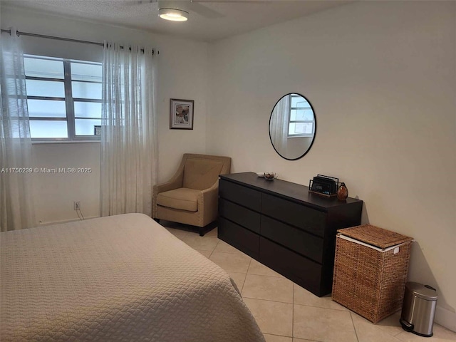 bedroom featuring light tile patterned floors and multiple windows