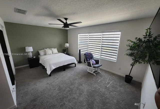 carpeted bedroom with baseboards, visible vents, ceiling fan, and a textured ceiling