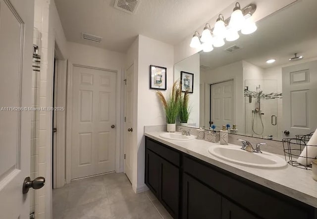 full bathroom with a stall shower, tile patterned flooring, visible vents, and a sink