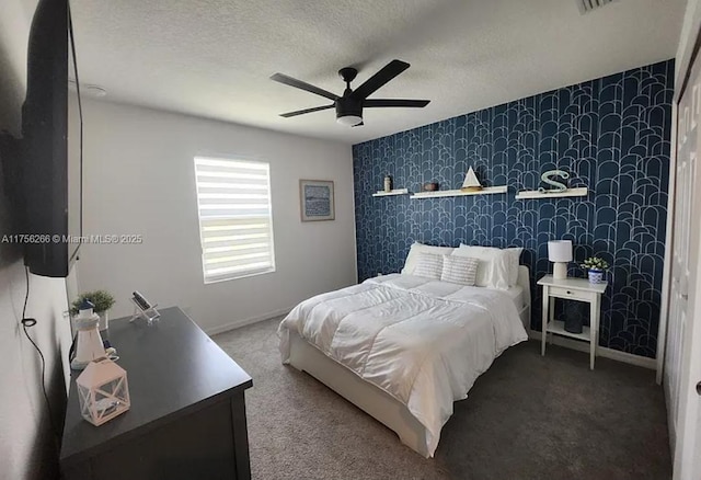 carpeted bedroom featuring wallpapered walls, baseboards, and a textured ceiling