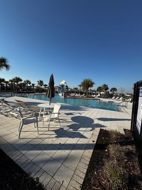 community pool featuring a patio area