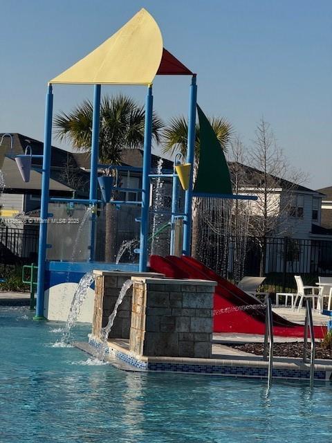 view of swimming pool with fence