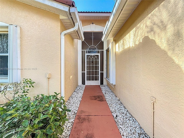 entrance to property with stucco siding