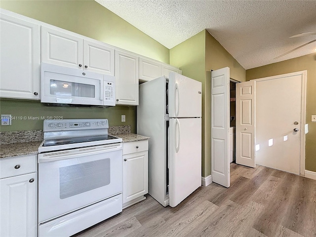 139 Sausalito Dr, Boynton Beach, FL 33436 - kitchen with vaulted ceiling, white appliances, white cabinetry, and light wood-style floors