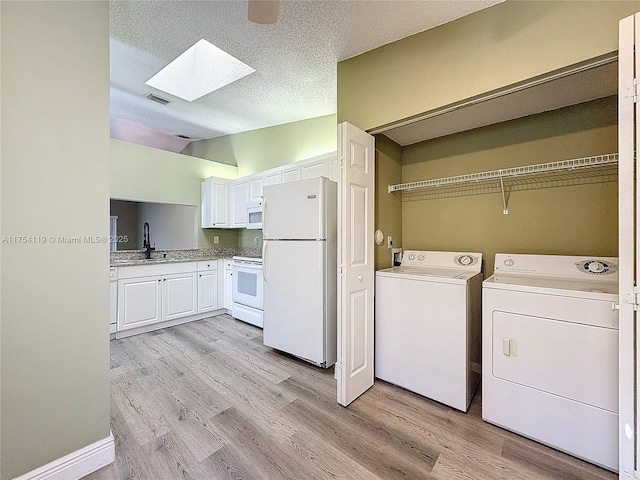 139 Sausalito Dr, Boynton Beach, FL 33436 - washroom with laundry area, a skylight, a sink, visible vents, and washer and clothes dryer