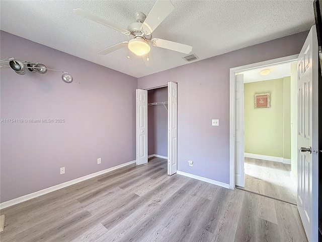139 Sausalito Dr, Boynton Beach, FL 33436 - unfurnished bedroom featuring light wood-style flooring, visible vents, and a textured ceiling
