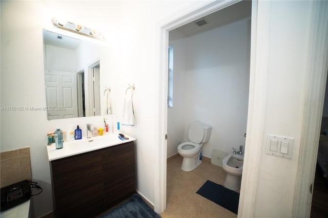 bathroom featuring visible vents, toilet, tile patterned flooring, vanity, and a bidet