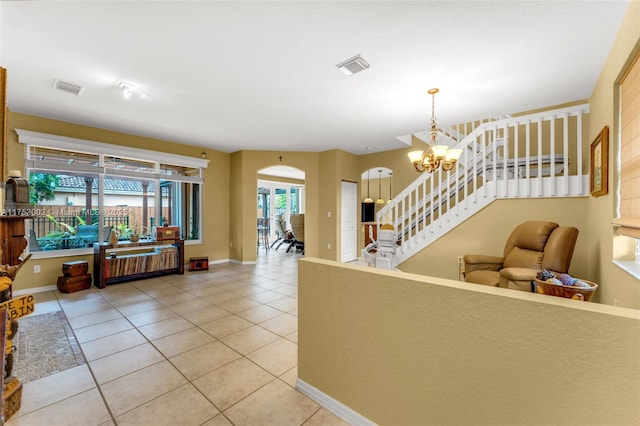 living area with a chandelier, light tile patterned flooring, visible vents, baseboards, and stairway