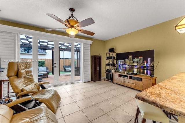 living room featuring ceiling fan, french doors, and light tile patterned flooring