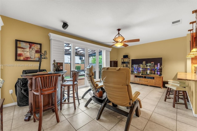 dining area with a ceiling fan, visible vents, baseboards, and light tile patterned floors