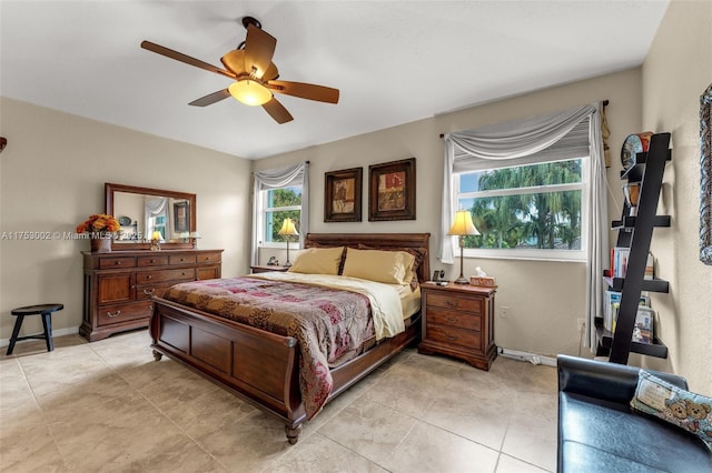 bedroom featuring light tile patterned flooring, a ceiling fan, and baseboards