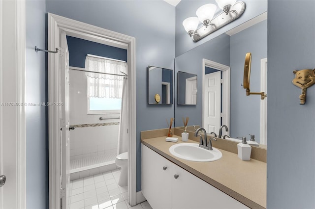 bathroom with tile patterned flooring, tiled shower, vanity, and toilet