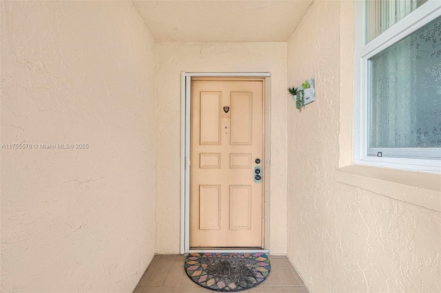 entrance to property featuring stucco siding