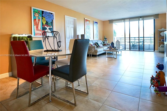 tiled dining room with baseboards and floor to ceiling windows