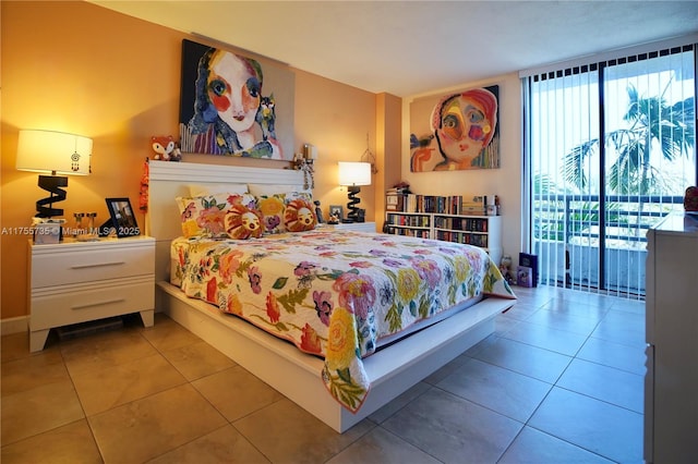 bedroom with expansive windows, access to outside, and tile patterned flooring