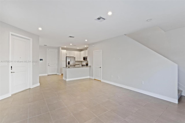 unfurnished living room featuring visible vents, recessed lighting, stairway, and baseboards