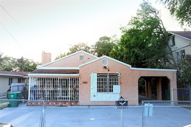 back of property featuring fence and stucco siding