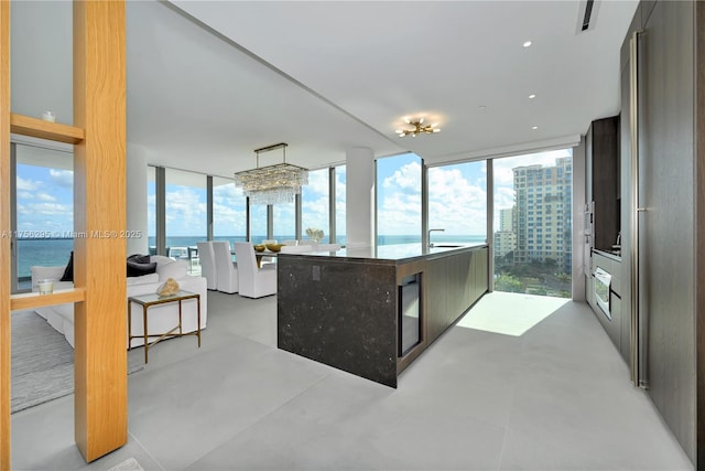 kitchen with finished concrete floors, expansive windows, visible vents, and a city view