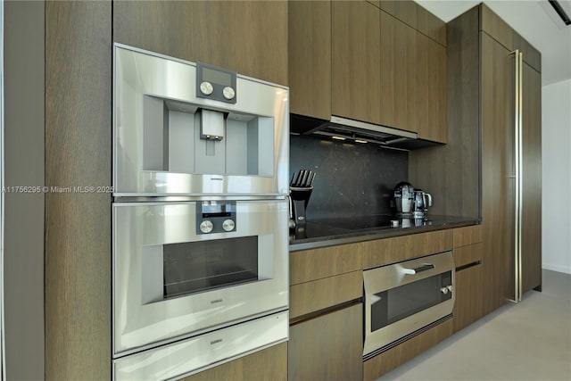 kitchen with decorative backsplash, modern cabinets, ventilation hood, stainless steel double oven, and a warming drawer