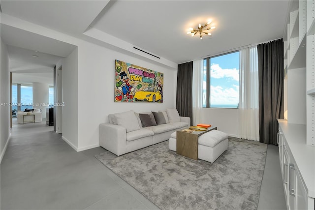 living area featuring concrete floors and baseboards