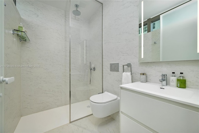 bathroom featuring a marble finish shower, toilet, marble finish floor, vanity, and tile walls