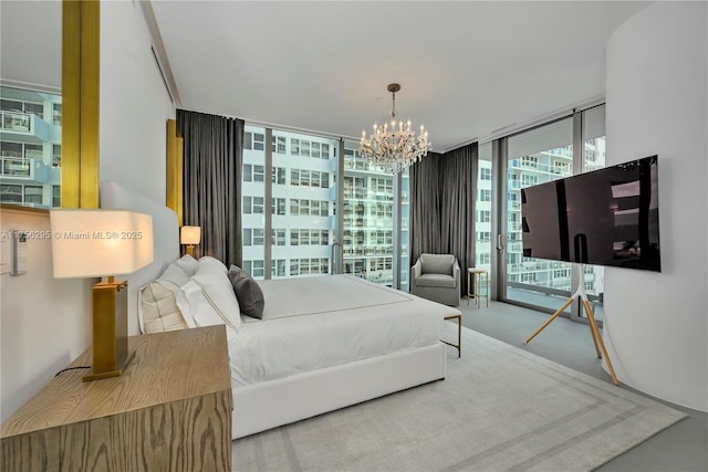 bedroom featuring an inviting chandelier, access to outside, and expansive windows