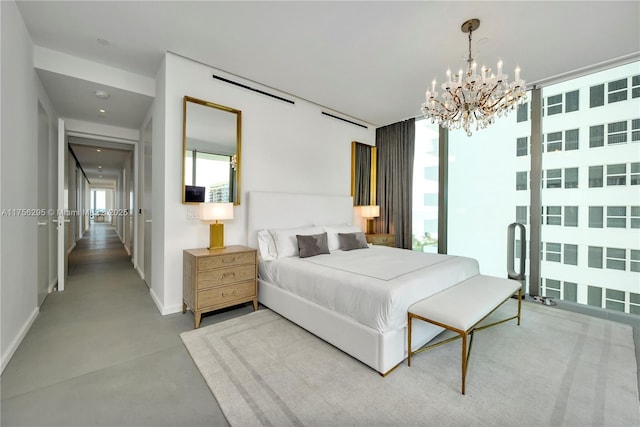 bedroom with concrete flooring, a chandelier, and baseboards