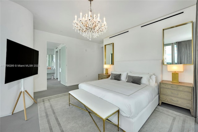 bedroom featuring an inviting chandelier and baseboards