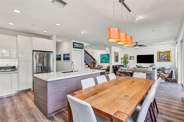 4471 Foxtail Ln, Weston, FL 33331 - dining area featuring recessed lighting, light wood finished floors, ceiling fan, visible vents, and stairway