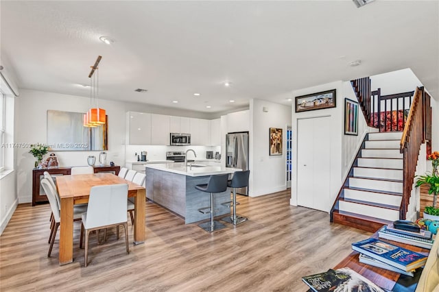 4471 Foxtail Ln, Weston, FL 33331 - dining area with light wood-style floors, stairway, and recessed lighting