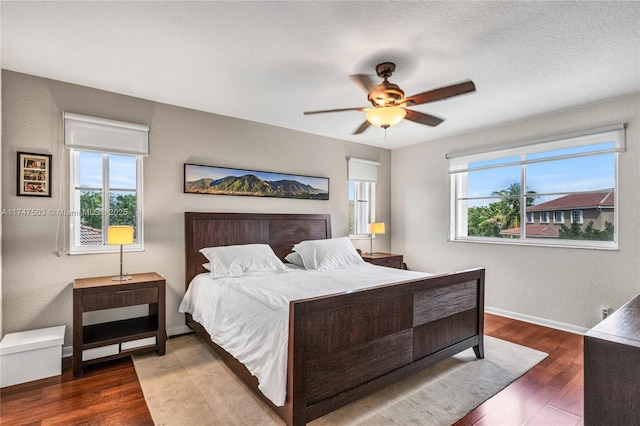 4471 Foxtail Ln, Weston, FL 33331 - bedroom featuring multiple windows, wood finished floors, baseboards, and a ceiling fan