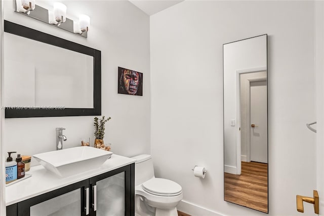 4471 Foxtail Ln, Weston, FL 33331 - bathroom with toilet, baseboards, vanity, and wood finished floors