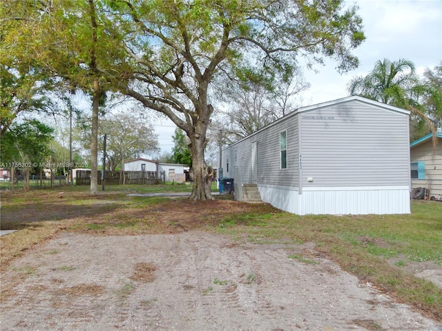 view of home's exterior featuring fence