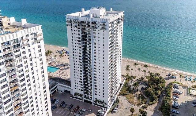 drone / aerial view featuring a beach view and a water view