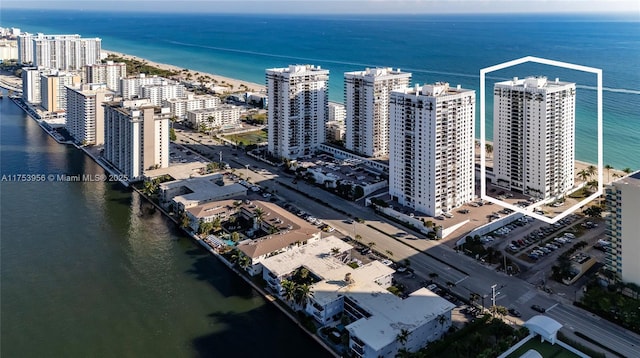 drone / aerial view featuring a view of city and a water view