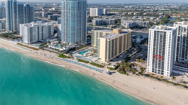 birds eye view of property with a water view, a city view, and a view of the beach