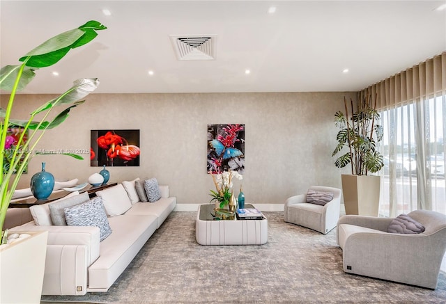 living area featuring visible vents and recessed lighting