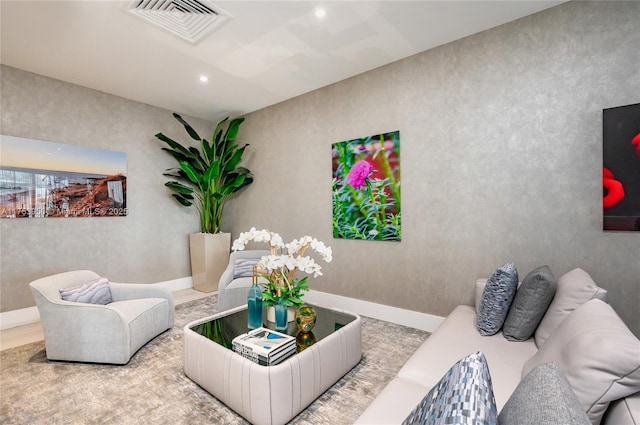 living area with recessed lighting, visible vents, and baseboards