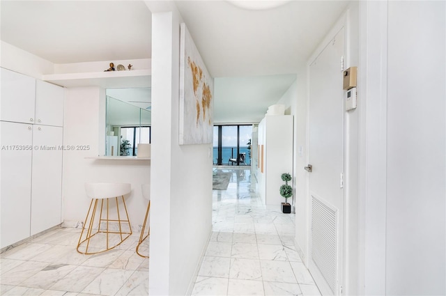 hall featuring visible vents and marble finish floor