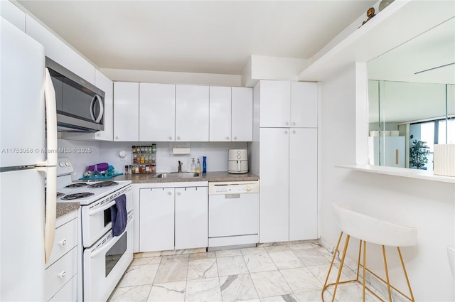 kitchen with marble finish floor, white appliances, white cabinetry, and a sink