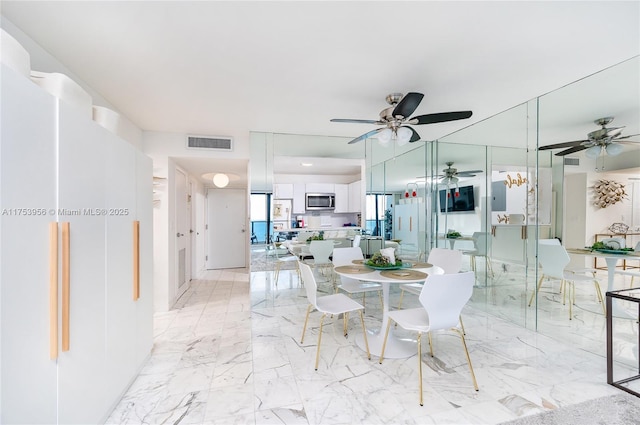 dining room with visible vents, marble finish floor, and ceiling fan