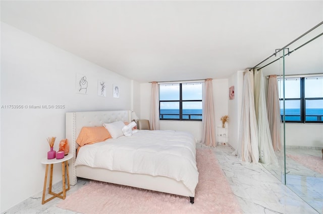 bedroom featuring marble finish floor