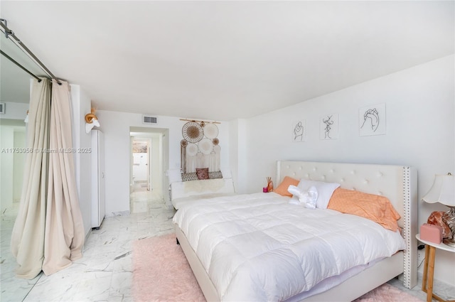 bedroom with visible vents and marble finish floor