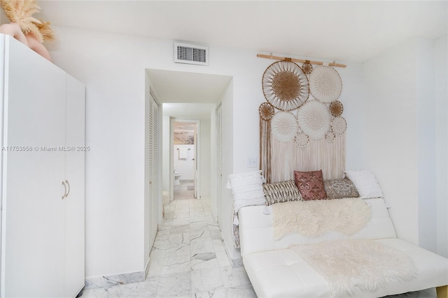 hall featuring visible vents and marble finish floor